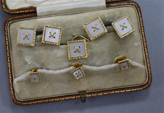 An early-mid 20th century cased six piece 18ct gold and mother of pearl dress stud set.